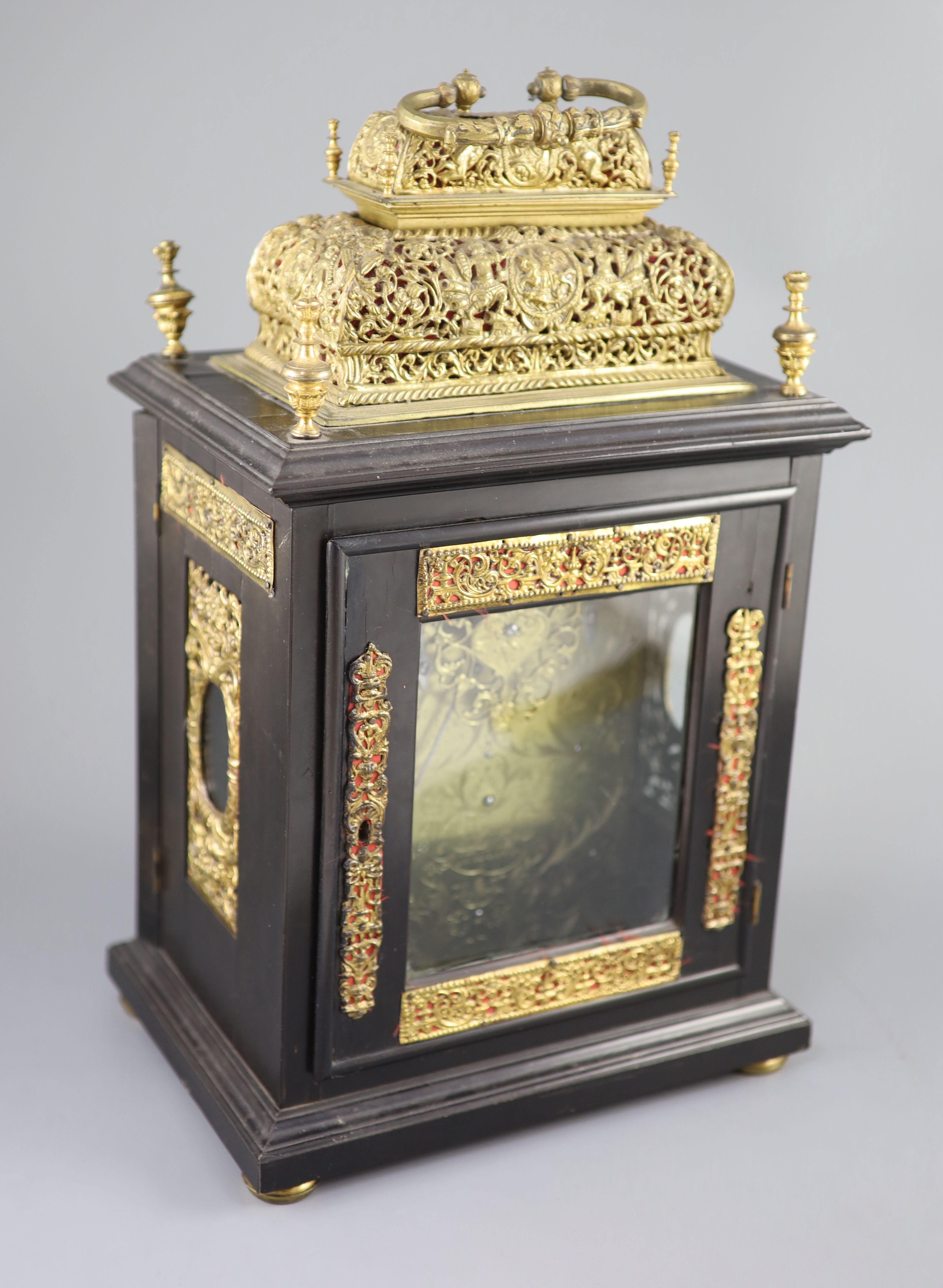 A William III ebonised cased and gilt metal double basket topped chiming and quarter repeating table clock, height 17in.